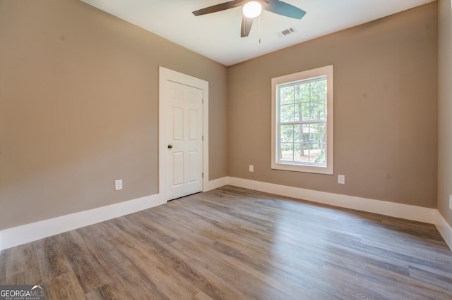 unfurnished room featuring ceiling fan and light wood-type flooring