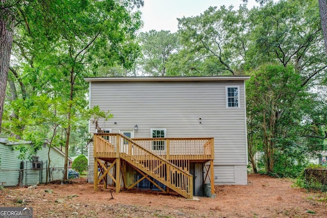 rear view of property featuring a wooden deck