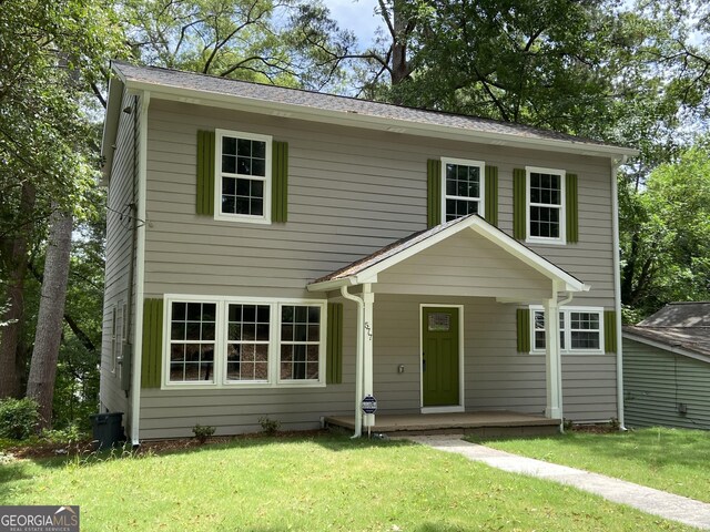 view of front facade featuring covered porch and a front yard