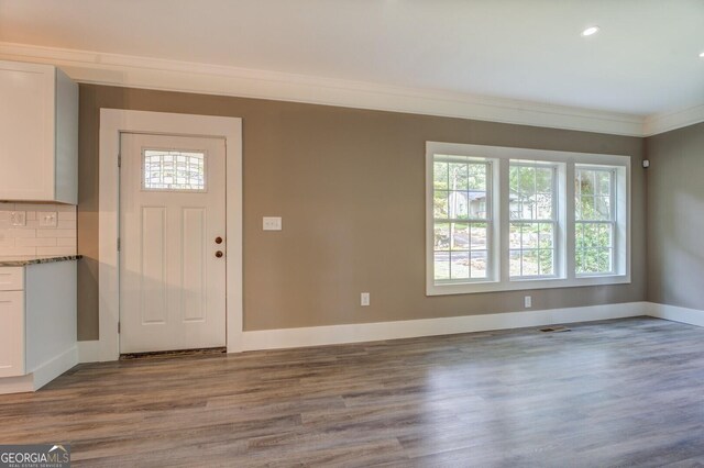 entryway with crown molding and light wood-type flooring