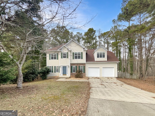 view of front of property with a front lawn and a garage