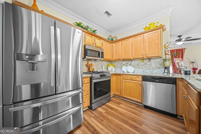 kitchen with tasteful backsplash, light stone counters, stainless steel appliances, crown molding, and light wood-type flooring