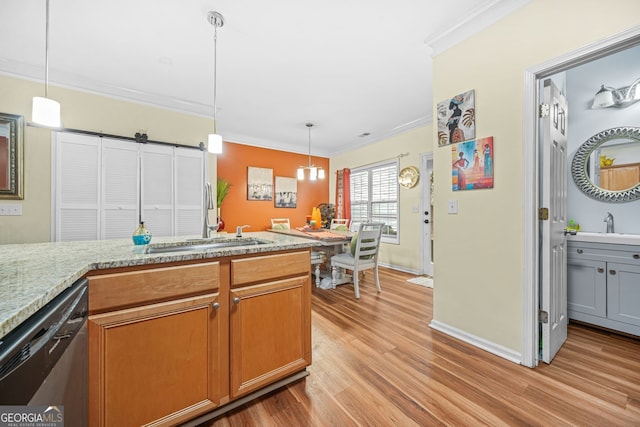 kitchen featuring light hardwood / wood-style flooring, light stone counters, ornamental molding, decorative light fixtures, and stainless steel dishwasher