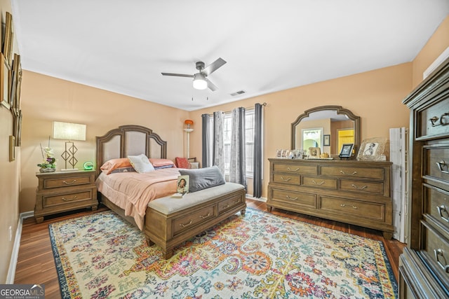 bedroom with dark wood-type flooring and ceiling fan