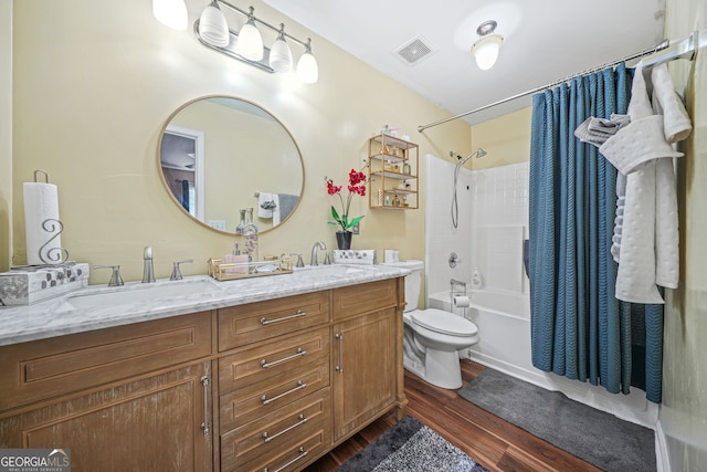 full bathroom featuring wood-type flooring, toilet, vanity, and shower / bath combo