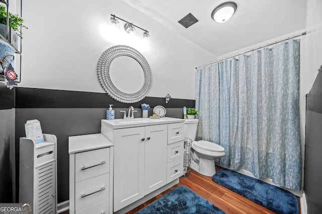 bathroom with vanity, wood-type flooring, and toilet