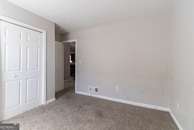 5876 Old Wellborn Trce, Lithonia, GA 30058 - unfurnished bedroom with carpet flooring and a textured ceiling
