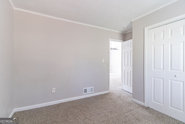 5876 Old Wellborn Trce, Lithonia, GA 30058 - unfurnished bedroom featuring carpet, ornamental molding, and a closet