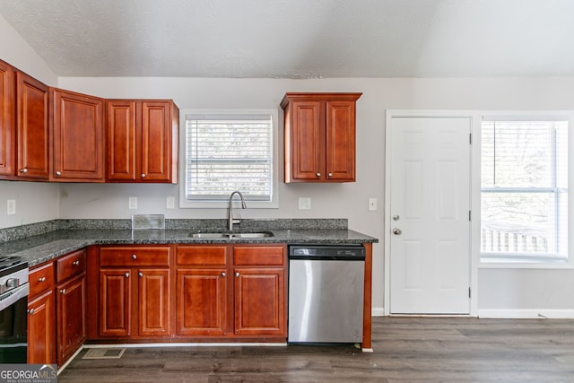 5876 Old Wellborn Trce, Lithonia, GA 30058 - kitchen featuring stainless steel appliances, dark wood-style floors, and dark stone countertops