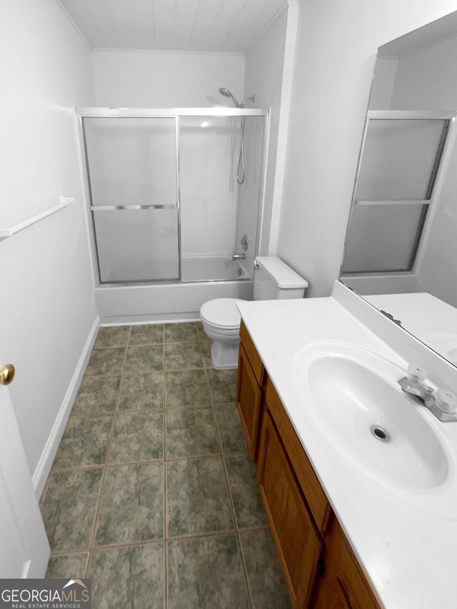 full bathroom featuring enclosed tub / shower combo, vanity, and toilet