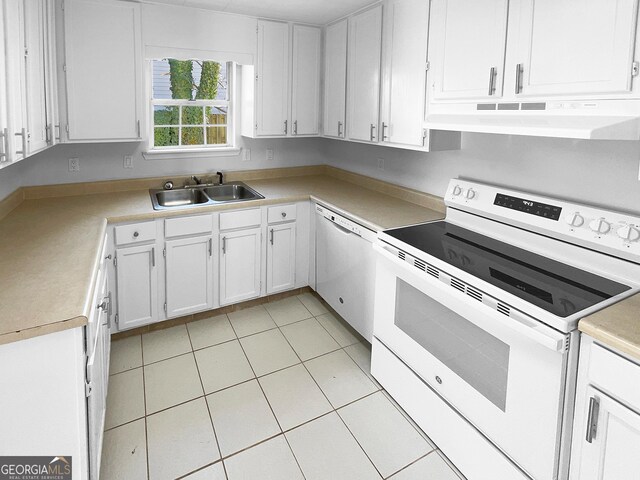 kitchen featuring sink, white appliances, light tile patterned floors, and white cabinets