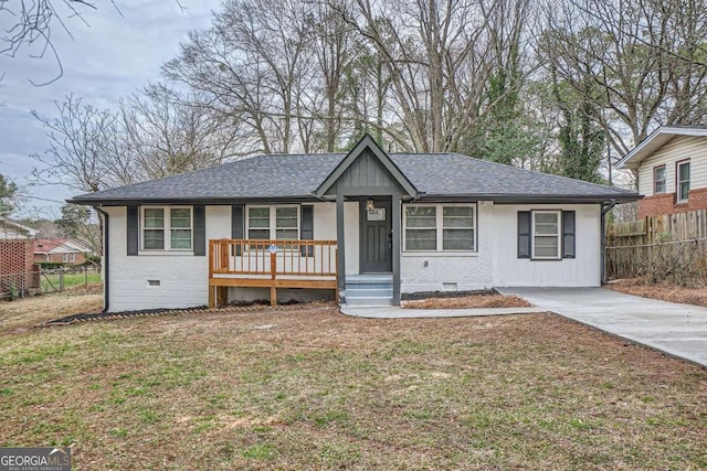 ranch-style home with a shingled roof, crawl space, brick siding, and fence