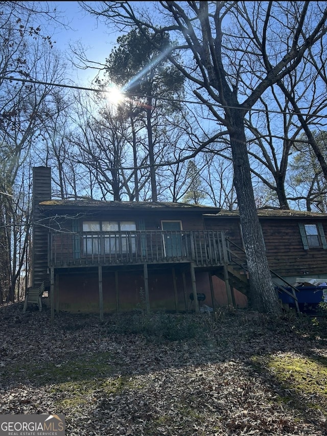 back of house featuring a deck