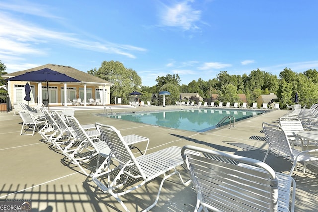 community pool featuring a patio area and fence