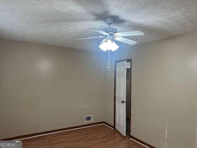 unfurnished room with hardwood / wood-style floors, a textured ceiling, and ceiling fan