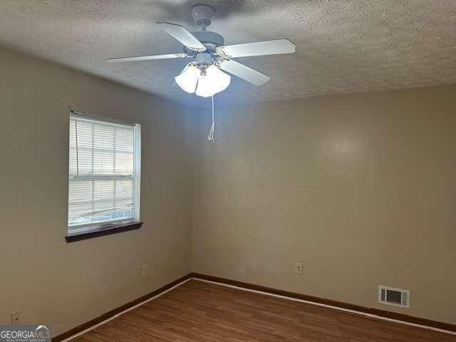 unfurnished room with hardwood / wood-style floors, a textured ceiling, and ceiling fan