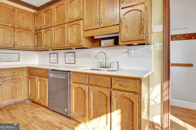 kitchen with dishwasher, sink, and light hardwood / wood-style flooring