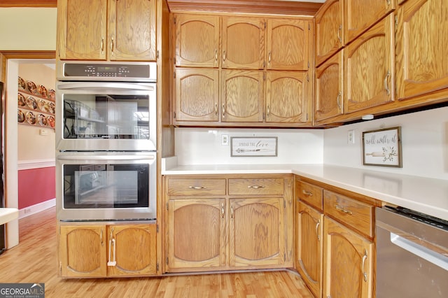 kitchen featuring appliances with stainless steel finishes and light hardwood / wood-style floors