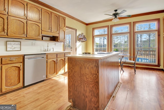 kitchen with stainless steel dishwasher, ornamental molding, a center island, and light wood-type flooring