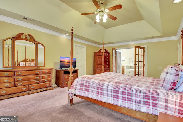 carpeted bedroom with french doors, ornamental molding, ceiling fan, and a tray ceiling