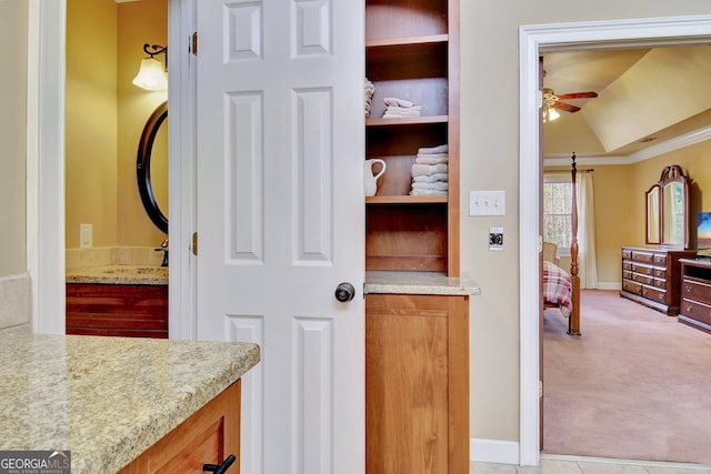 bathroom with ornamental molding, vaulted ceiling, sink, and ceiling fan