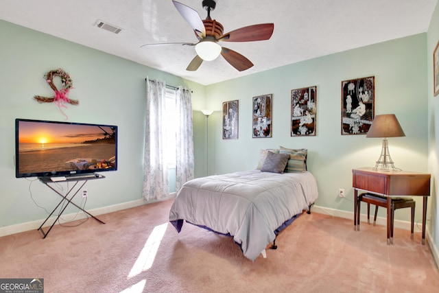 bedroom featuring light colored carpet and ceiling fan