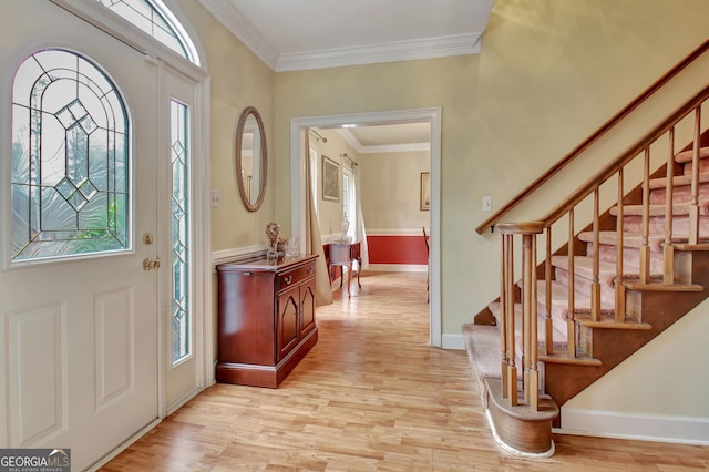 entryway with crown molding and light wood-type flooring