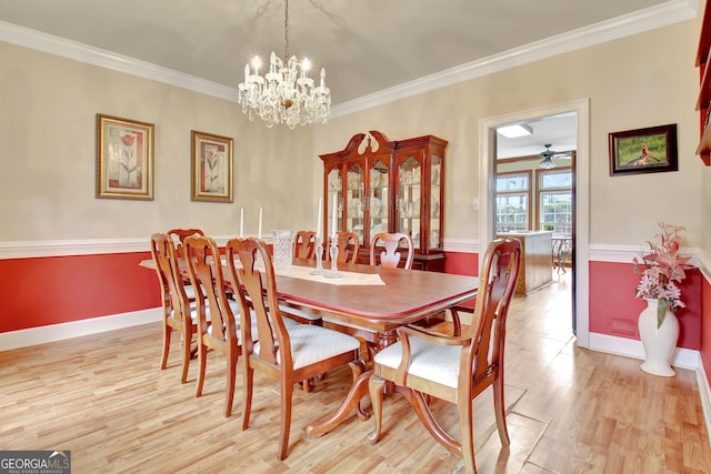 dining room with crown molding, ceiling fan with notable chandelier, and light hardwood / wood-style flooring