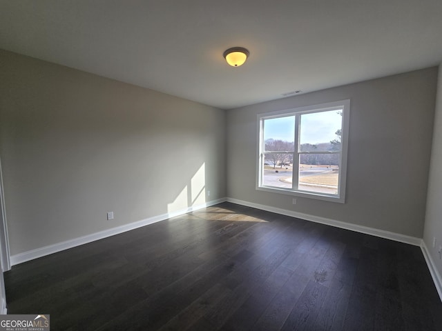 empty room featuring dark wood-type flooring