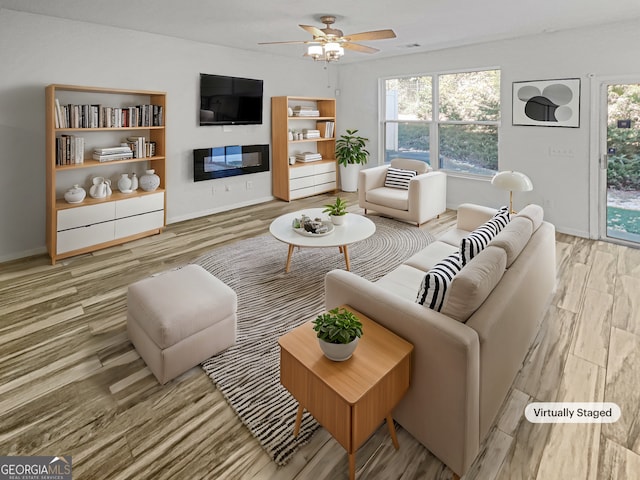 living room with light wood-type flooring and ceiling fan