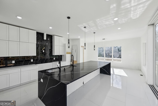 kitchen featuring pendant lighting, white cabinetry, and a large island