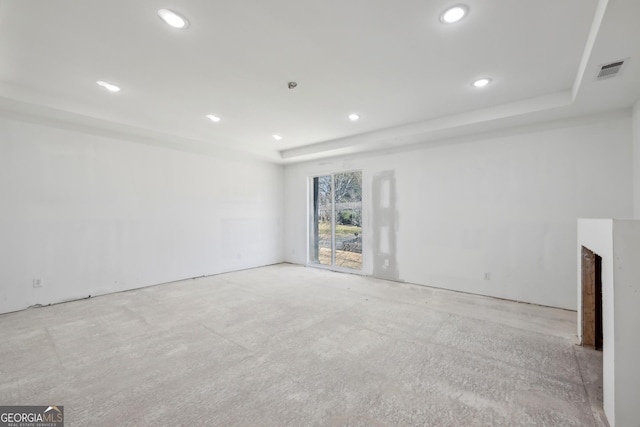 unfurnished living room featuring a raised ceiling