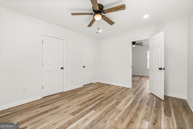 unfurnished bedroom featuring ceiling fan and light hardwood / wood-style flooring