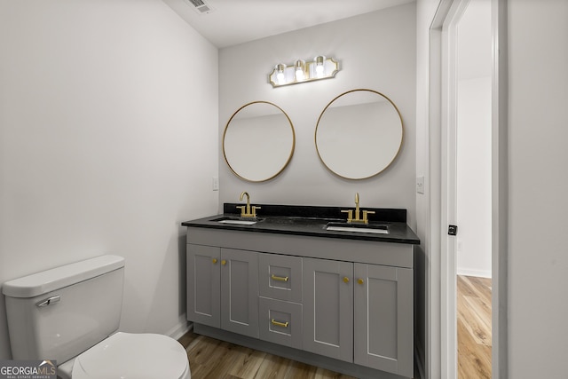 bathroom featuring vanity, hardwood / wood-style floors, and toilet