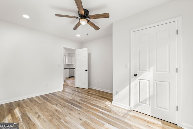 unfurnished bedroom with ceiling fan and light wood-type flooring