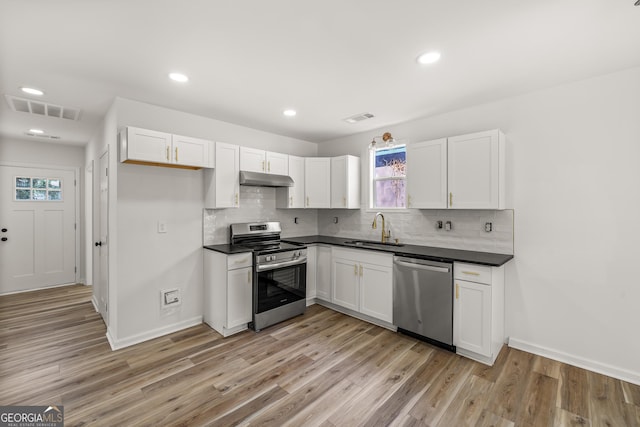 kitchen featuring light wood-type flooring, appliances with stainless steel finishes, sink, and white cabinets