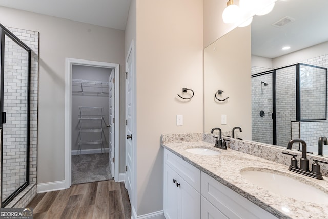 bathroom featuring vanity, hardwood / wood-style floors, and walk in shower