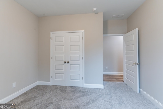 unfurnished bedroom featuring carpet floors and a closet