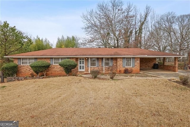 ranch-style house featuring a front lawn and a carport