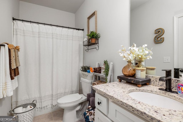 bathroom with vanity, walk in shower, tile patterned floors, and toilet