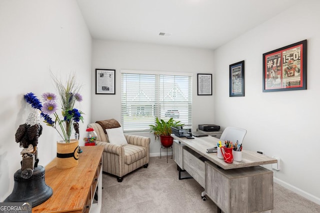 office area featuring visible vents, baseboards, and light colored carpet
