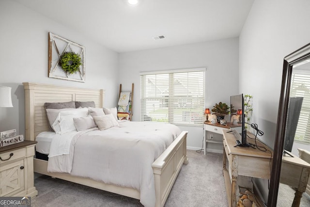 bedroom with visible vents, light carpet, and multiple windows