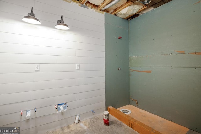 bathroom with unfinished concrete flooring