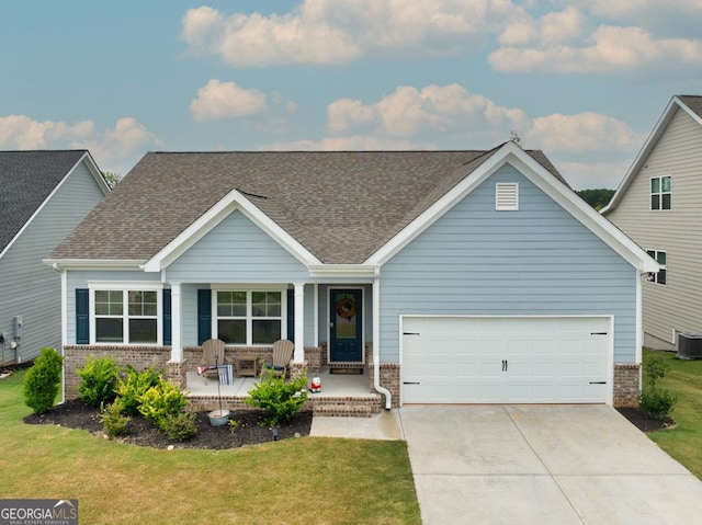 craftsman inspired home with central AC, a garage, covered porch, and a front lawn