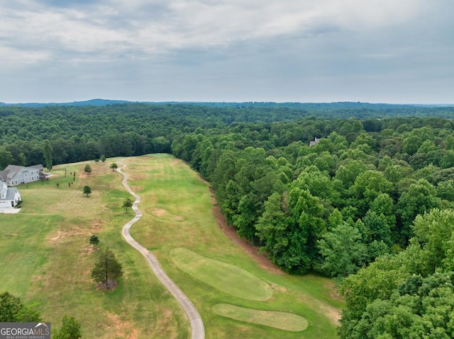 birds eye view of property featuring a forest view