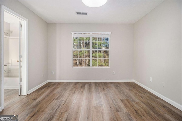 unfurnished room featuring hardwood / wood-style flooring