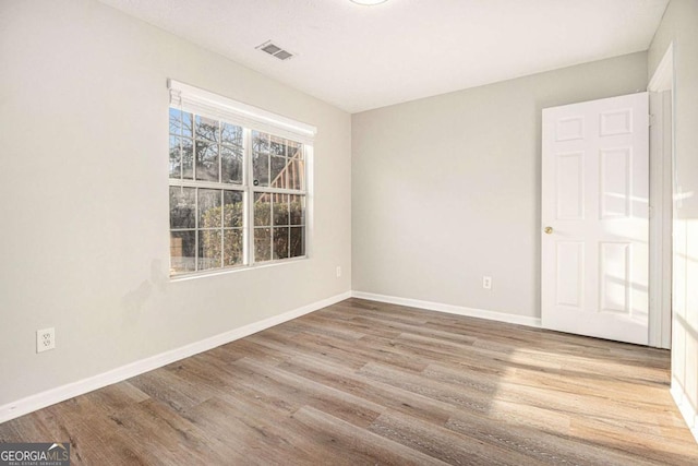 unfurnished room featuring light hardwood / wood-style floors