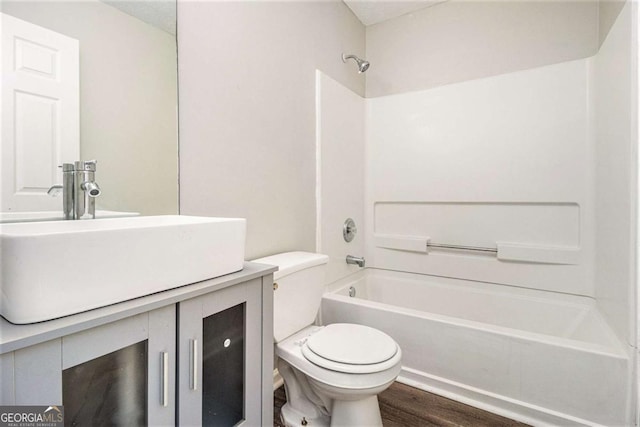 full bathroom with shower / tub combination, vanity, toilet, and wood-type flooring