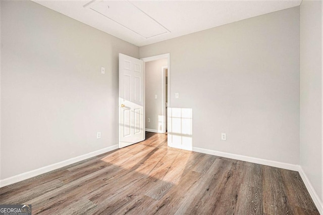 unfurnished room featuring hardwood / wood-style flooring