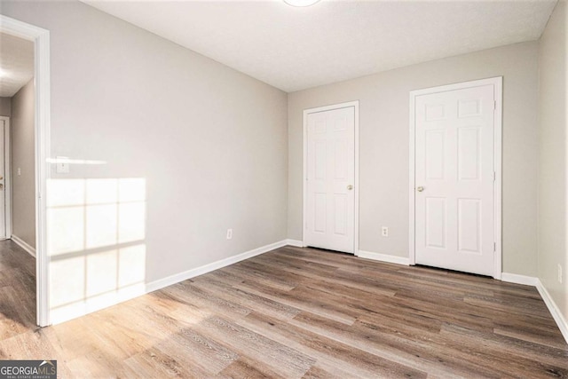 unfurnished bedroom featuring wood-type flooring